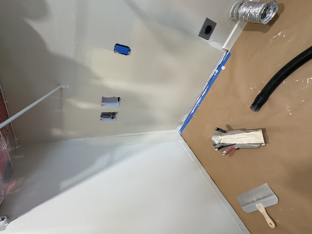 Drywall repair in progress with taping knife and prepped wall, Jefferson County WA